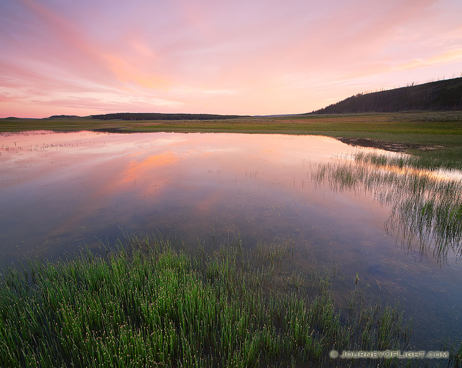 Clouds are illuminated with bright reds and oranges during a vivid sunset in the Hayden Valley of Yellowstone National Park in Wyoming. - Yellowstone National Park Photography