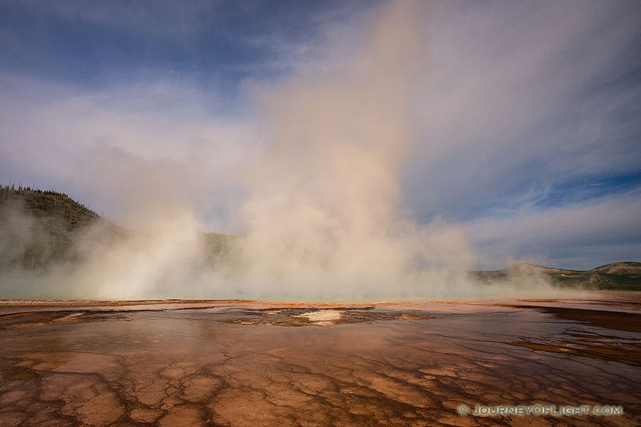 Steam from the Grand Prismatic Spring in the Middle Geyser basin rises with a warm hue from the early morning sun. - Yellowstone National Park Photography