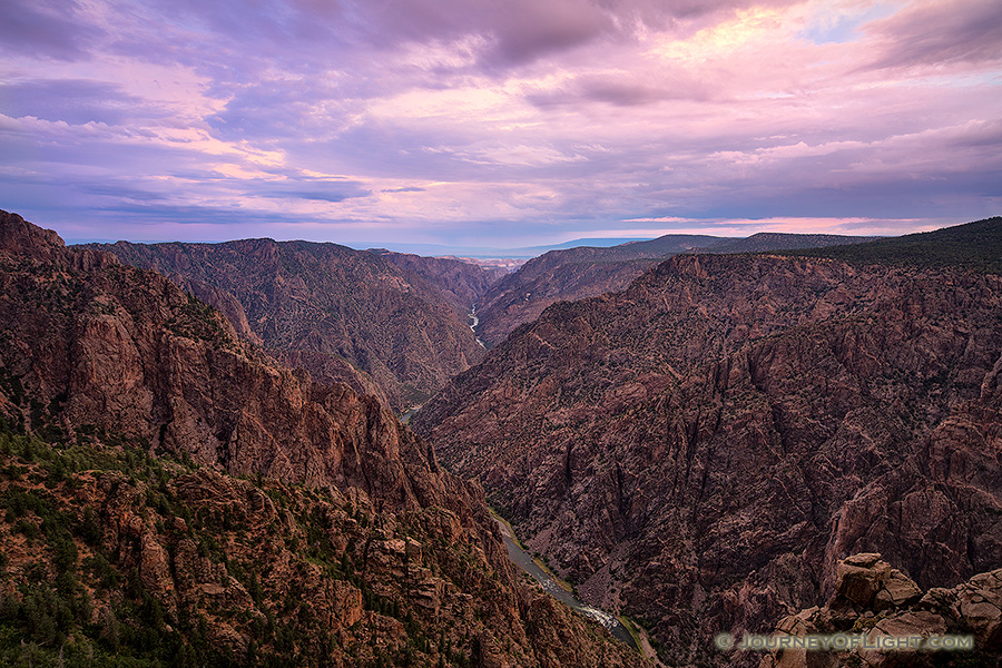 Pastel hues dominate the sky and are reflected throughout the canyon during a beautiful summer sunrise. - Colorado Photography