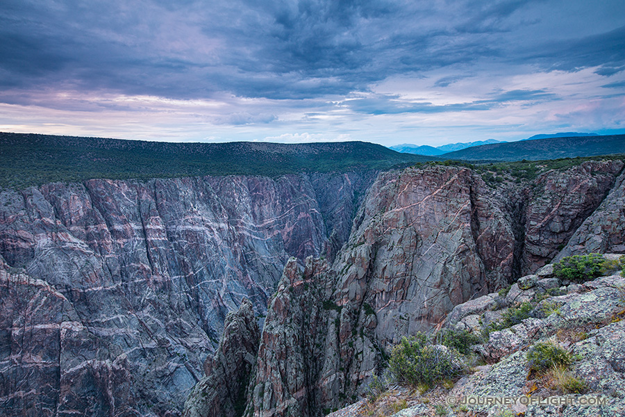 Dusk descends on the Black Canyon of the Gunnison.  The cool blue hues began to prevail throughout the sky and are reflected in the canyon walls. - Colorado Photography