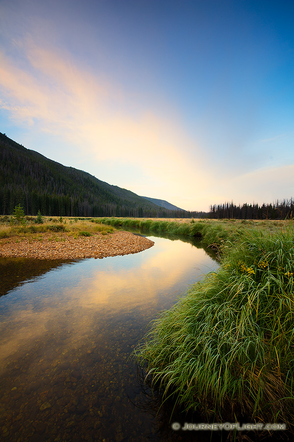 On the west side of Rocky Mountain National Park, the North Inlet stream snakes through a meadow and reflects a beautiful autumn sunrise. - Colorado Photography