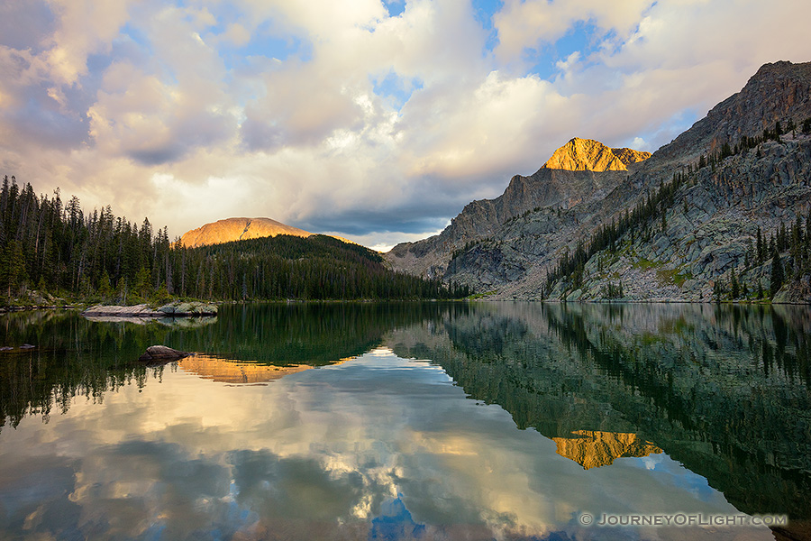 Mountains glow with the last light of a cool autumn day while an almost perfect reflection shimmers in Nanita Lake. - Colorado Photography
