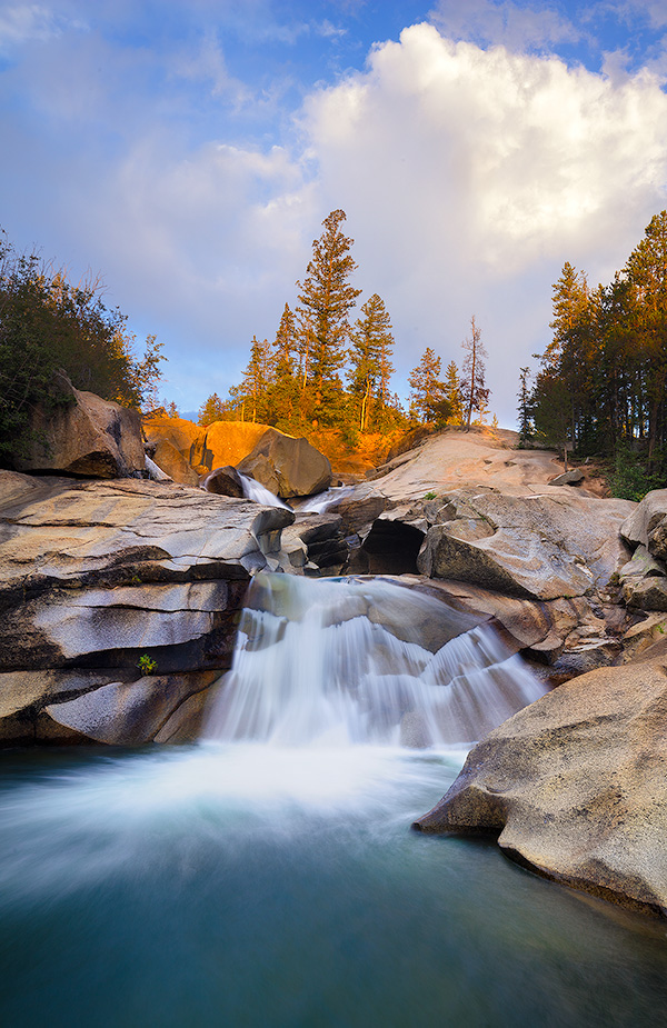 The soothing swoosh of the waterfall was the other sound as the warm last light strikes trees above the Grottos Waterfall in the White River National Forest in Colorado. - Colorado Photography