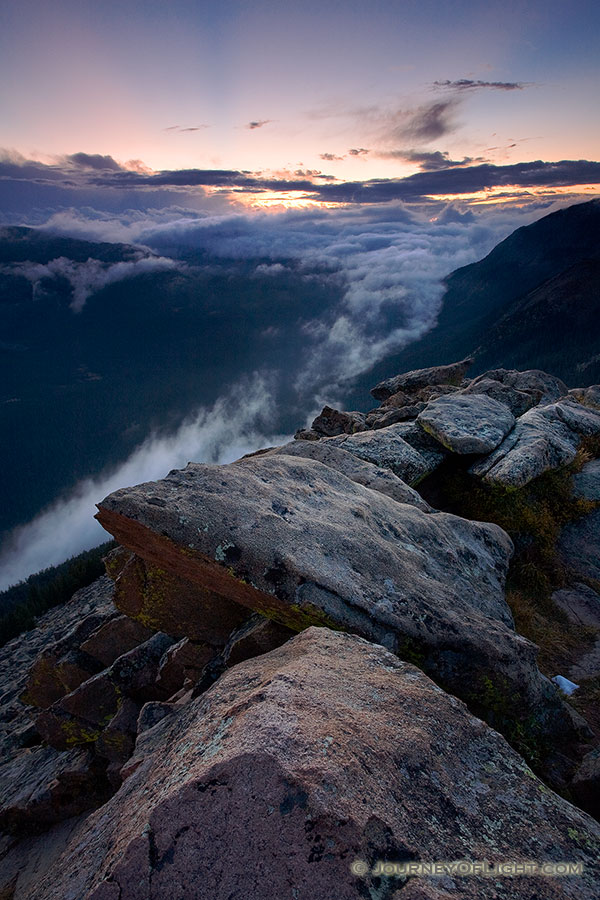 Clouds gather in the valleys of Rocky Mountain National Park as the sun sets in the distance. - Rocky Mountain NP Photography