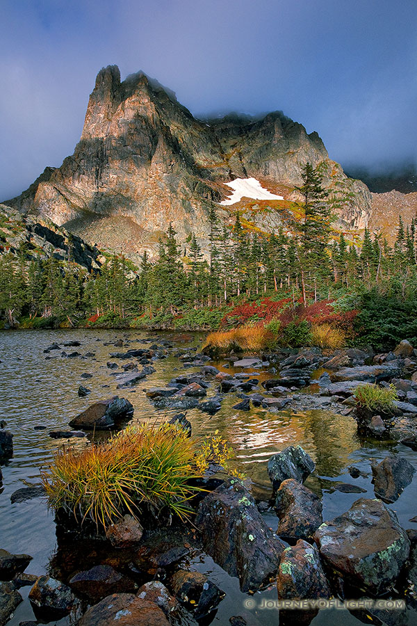 Light filters through the clouds during a short break in a rain storm that brought rain and sleet to Lake Helene. - Rocky Mountain NP Photography