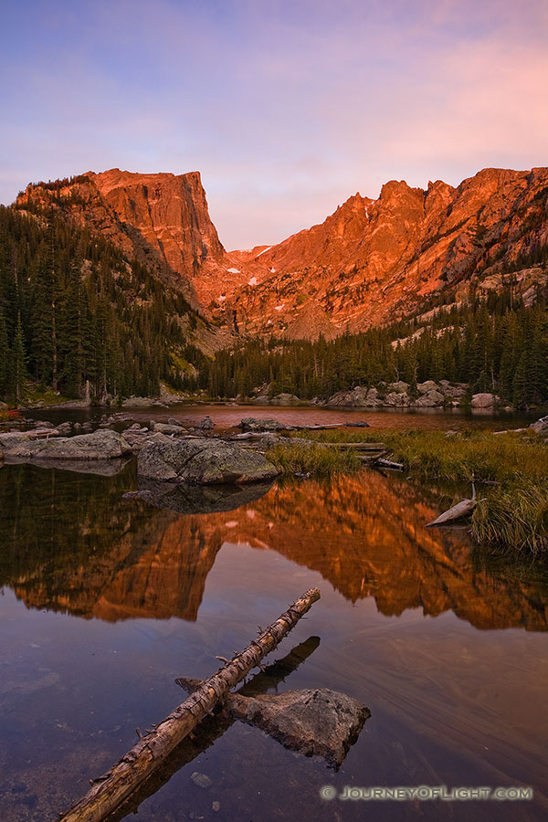 Early on a cool autumn morning, Dream Lake glows with the reflected light of the rising sun. - Rocky Mountain NP Photography