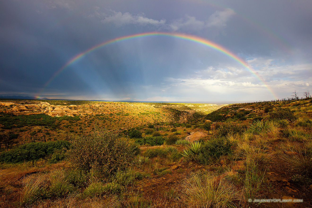 After an intense day of rain a beautiful rainbow appears over a canyon in the west area of Mesa Verde National Park. - Colorado Picture