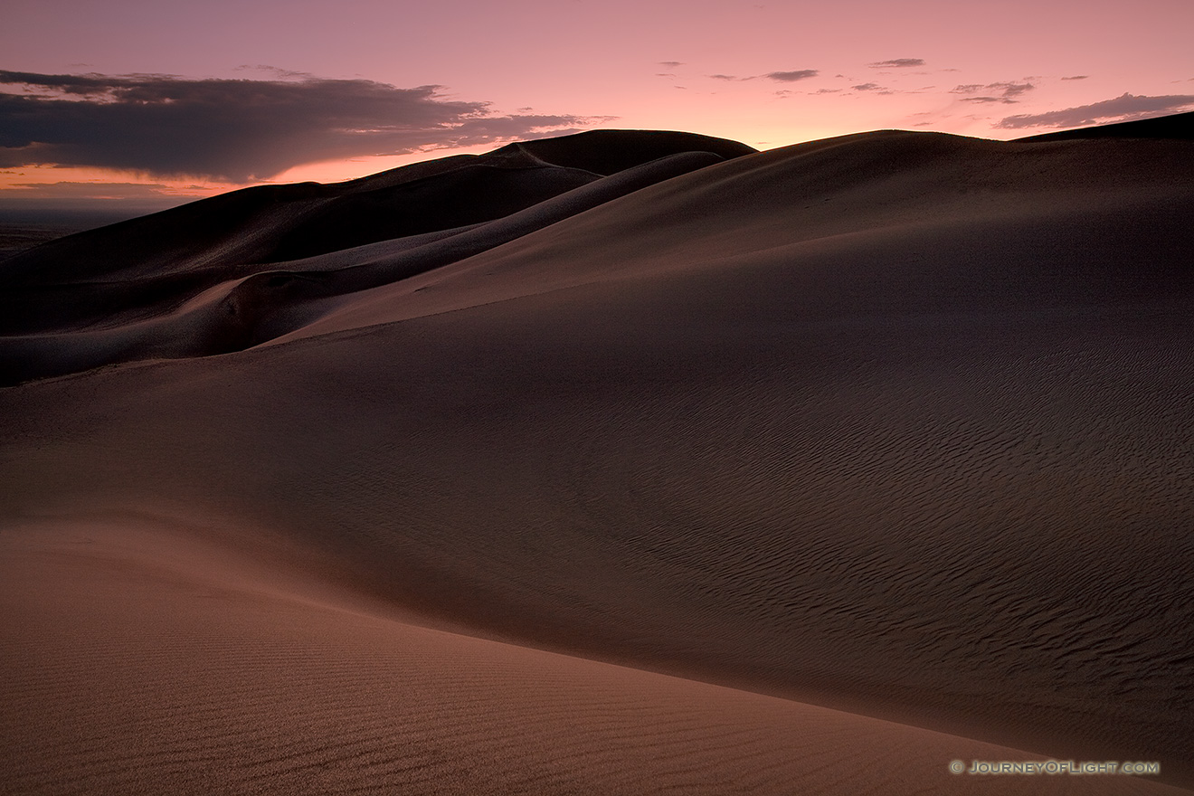 As I photographed this scene, I almost imagined myself in a foreign land as the sun dipped below the horizon.  The shapes of the dunes in this photo become abstract lines and patterns in the late dusk light. - Great Sand Dunes NP Picture