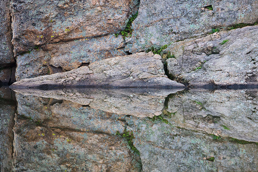 An abstract photograph of rocks reflected in Sylvan Lake in Custer State Park, South Dakota. - South Dakota Photography