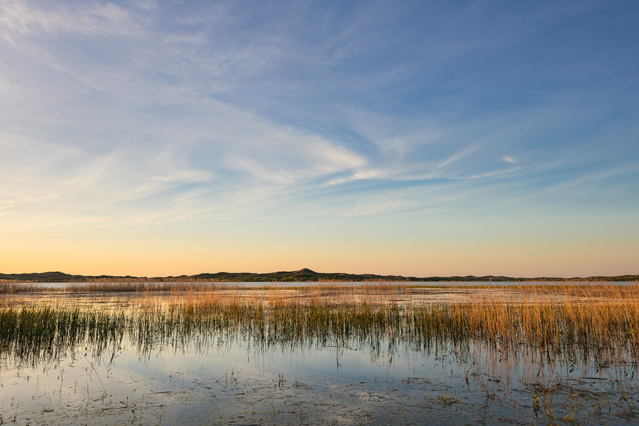 On a cool spring evening, sunset falls over Willow Lake nestled deep in the Sandhills of Nebraska. - Nebraska Photography