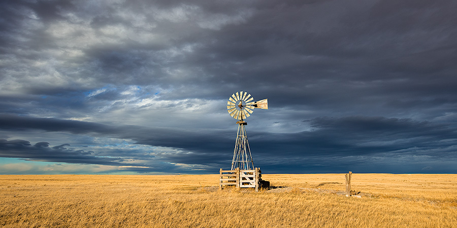 Scenic landscape panoramic photograph of a windmill and a storm at Oglala National Grasslands. - Nebraska Photography