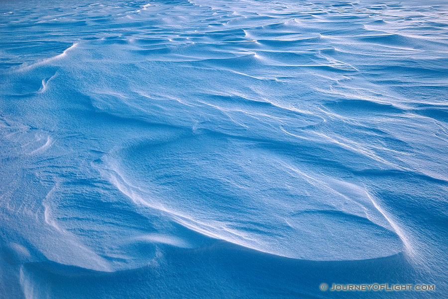 Snow drifts across Wehrspann Lake at Chalco Hills Recreation Area on a frigid February day. - Nebraska Photography