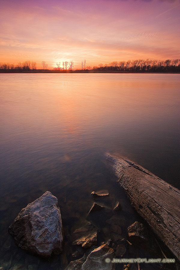 Clouds in the sky reflect the setting sun as sunset decends upon DeSoto Bend National Wildlife Refuge. - DeSoto Photography