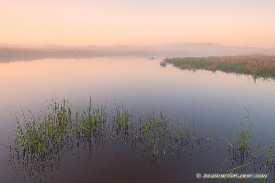 When I visited Crescent Lake National Wildlife Refuge this past May one of the things that struck me about the refuge was the quiet and remoteness.  Early one morning I hiked out to a little marshy area that was completely encased in fog.  I setup on the edge of one of the marshes and watched as the fog rolled through and eventually burned off.  The only sounds were the quacks of some ducks on a nearby lake and the rustle of prairie grass in a light breeze. - Nebraska Photography