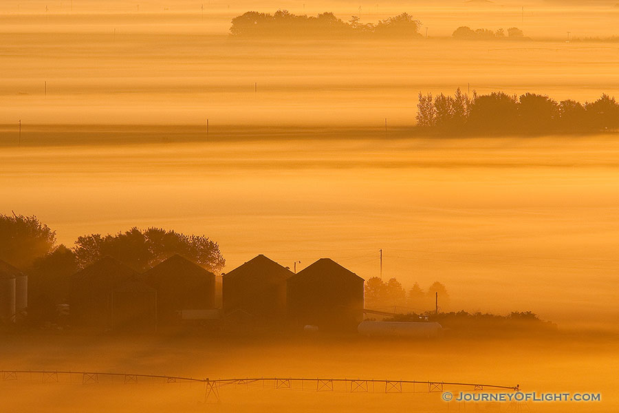 Sunlight grazes the fog as it rolls through the countryside across the Missouri from the Scenic Overlook at Ponca State Park in Dixon County. - Ponca SP Photography