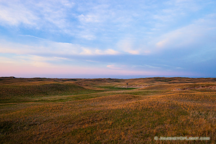 The last light of Day illuminates a windmill nestled in the sandhills on the western edge of Halsey National Forest. - Sandhills Photography