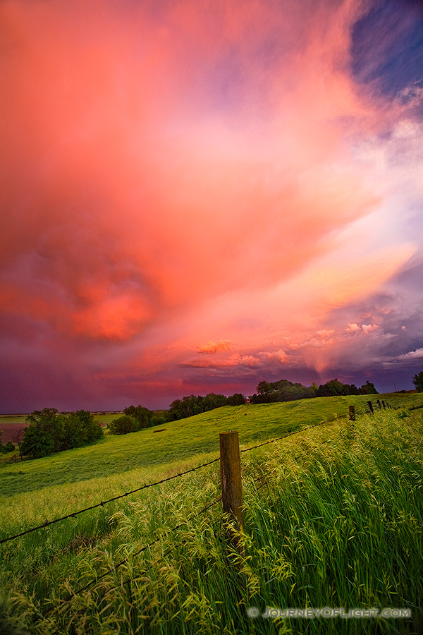 A photograph of one of a stunning display of sunset light illuminating high clouds following a late afternoon intense storm on the plains of Nebraska. - Nebraska Photography