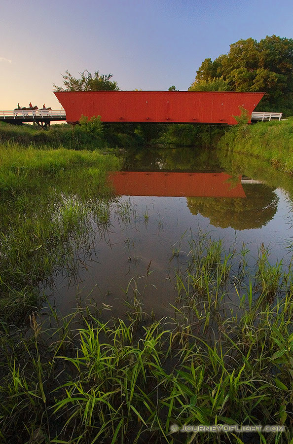 3 riders cross Hogback bridge in Iowa one of the famous bridges of Madison County. - Iowa Photography