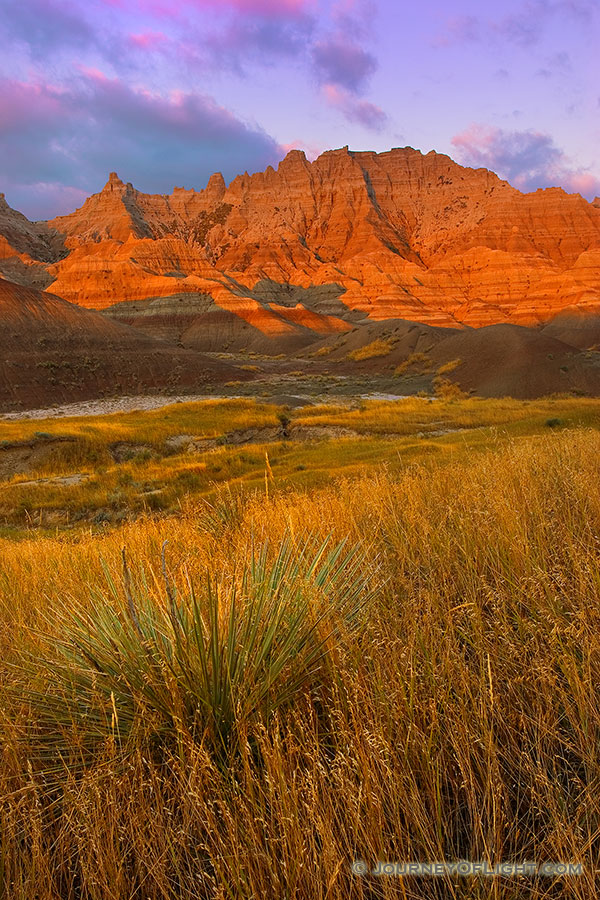 The morning sun emits a glow that radiates orange off the unusual formations in the Badlands National Park. - Badlands NP Photography