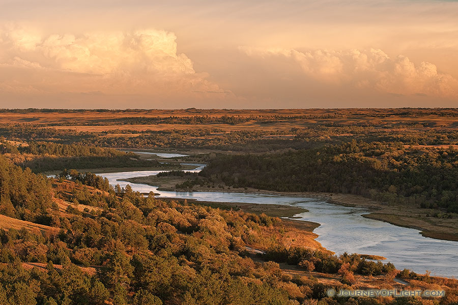 Storm clouds hover over the snaking Niobrara River near sunset in Keha Paha County in north central Nebraska. - Nebraska Photography