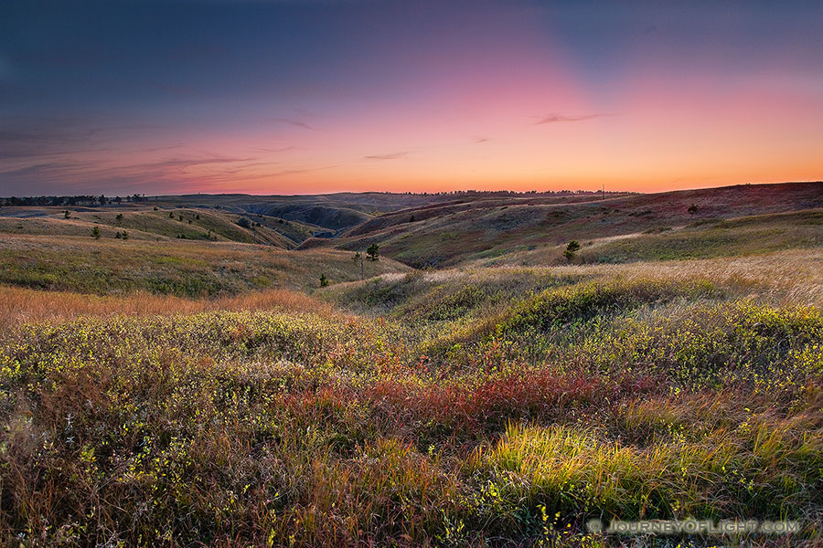 On an early fall evening, the final rays of the sun are briefly visible across Chadron State Park, Nebraska. - Nebraska Photography