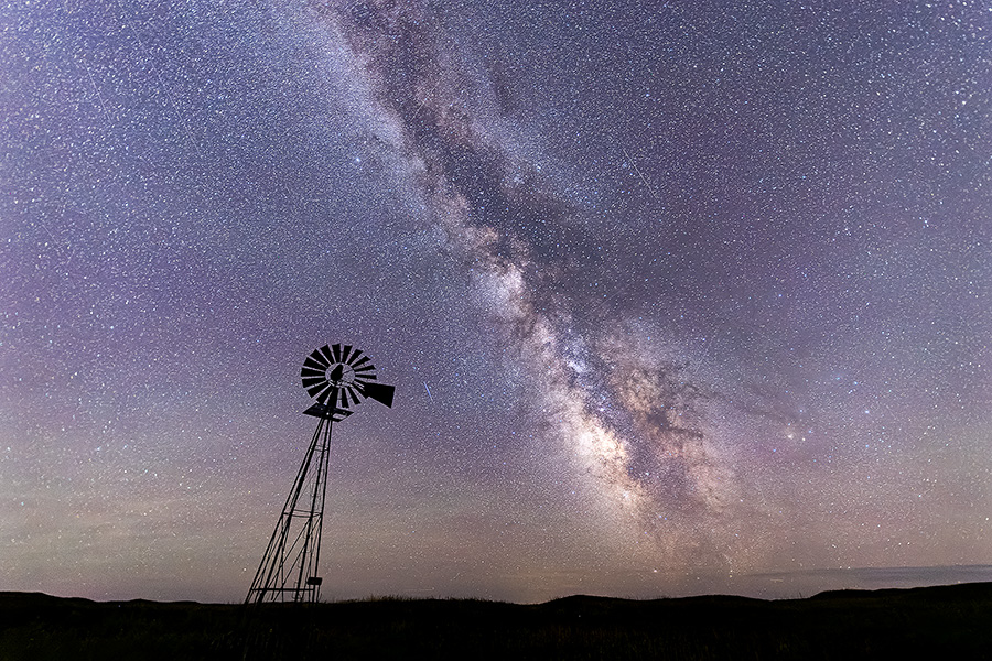A scenic landscape photograph of a windmill and the Milky Way in the sandhills of Nebraska. - Nebraska Photography