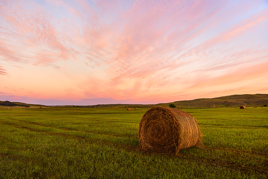 A scenic landscape photograph of hay bales and solitude in the sandhills of Nebraska. - Nebraska Photography