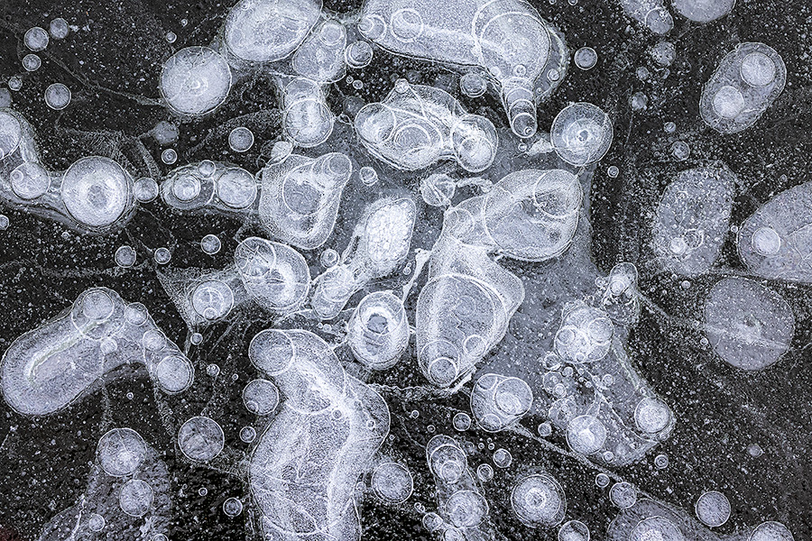 An abstract composition of bubbles under the ice at Shadow Lake, Nebraska. - Nebraska Photography