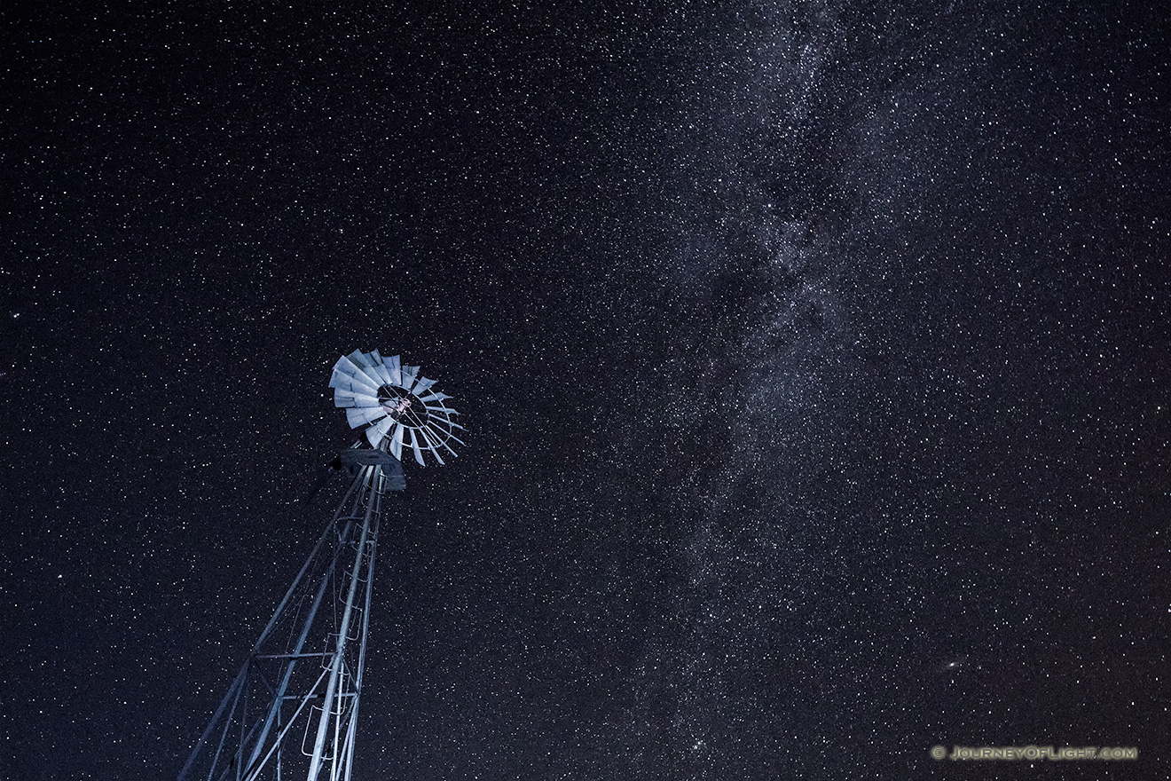 A Nebraska landscape scenic photograph of a windmill under a night sky with lots of stars. - Nebraska Picture