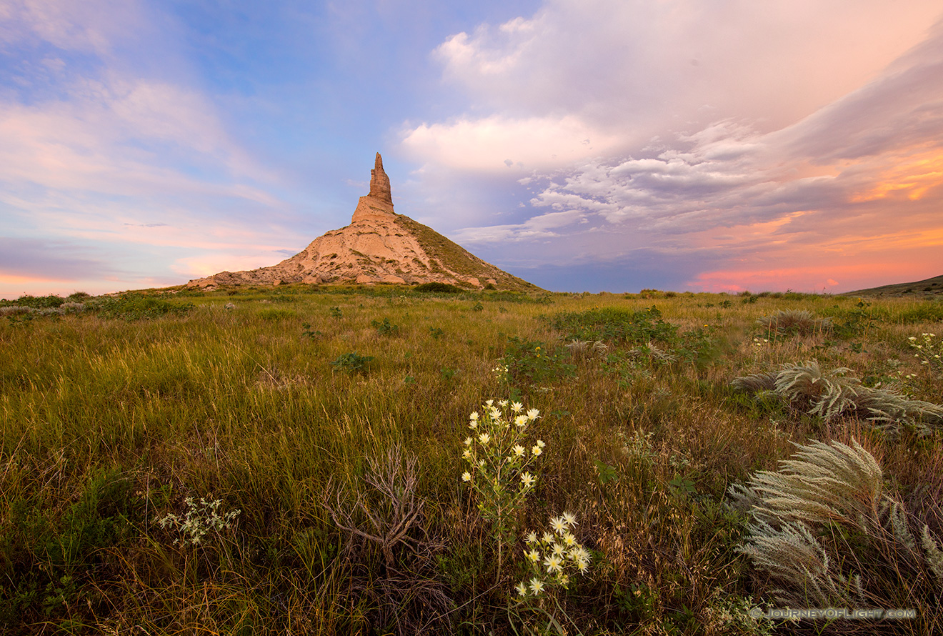 A scenic landscape photograph of the sunset and Chimney Rock National Historic Site. - Nebraska Picture
