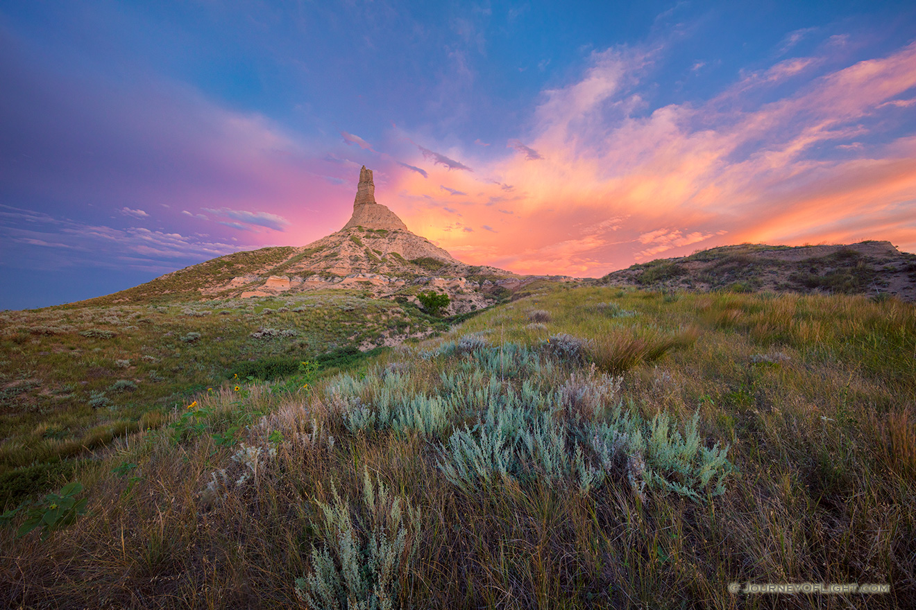 A scenic landscape photograph of a sunset and Chimney Rock National Historic Site. - Nebraska Picture