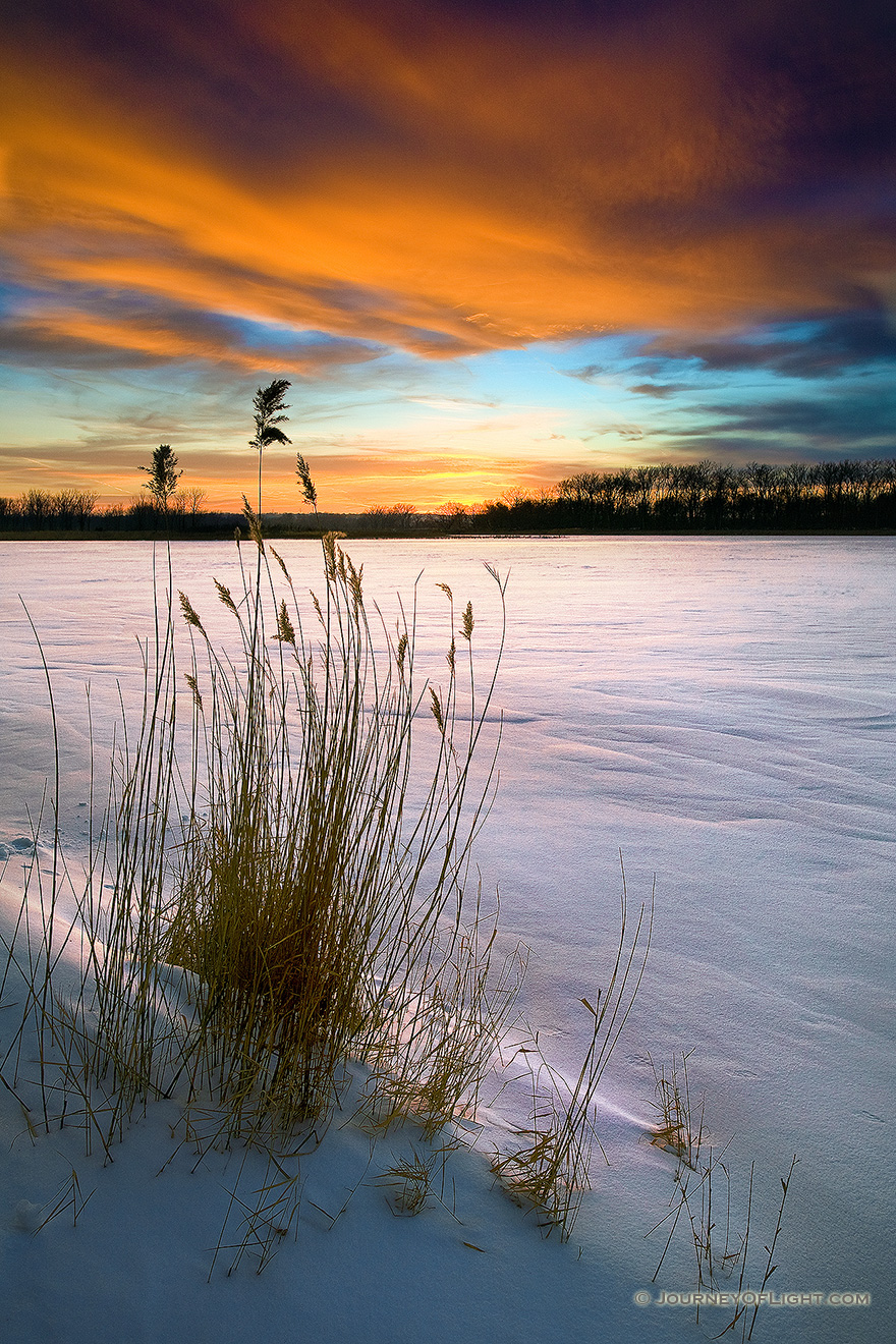 As the sun dipped below the horizon, the clouds lit up in the sky across the snow covered DeSoto Lake at DeSoto National Wildlife Refuge. - DeSoto Picture