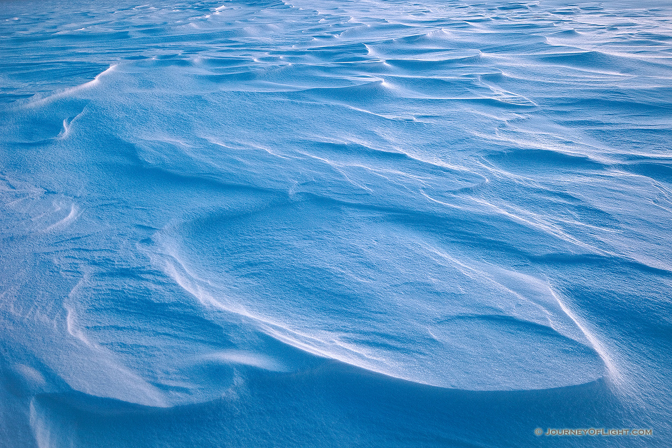 Snow drifts across Wehrspann Lake at Chalco Hills Recreation Area on a frigid February day. - Nebraska Picture