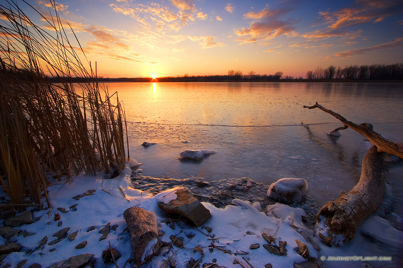 The sun reflects off a frozen lake in DeSoto National Wildlife Refuge in eastern Nebraska. - DeSoto Picture