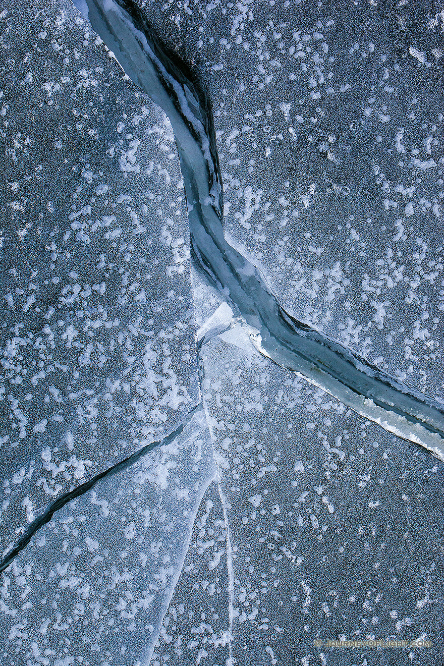 Deep cracks form in the ice from frigid cold weather on Lake Wehrspann at Chalco Hills, Nebraska. - Nebraska Picture