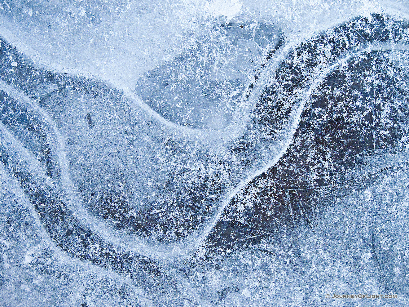 Bubbles and lines form an abstract pattern in the frozen ice in Stone Creek at Platte River State Park. - Platte River SP Picture