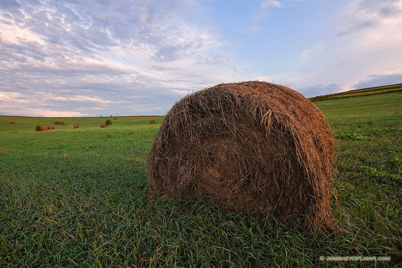 On a cool, early summer's morning, dew and sunlight kiss recently baled hay on a field in northwestern Nebraska. - Nebraska Picture