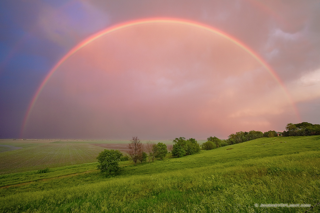 After an intense midwestern spring storm, from a Nebraska hilltop, an entire rainbow arches through the sky. - Nebraska Picture