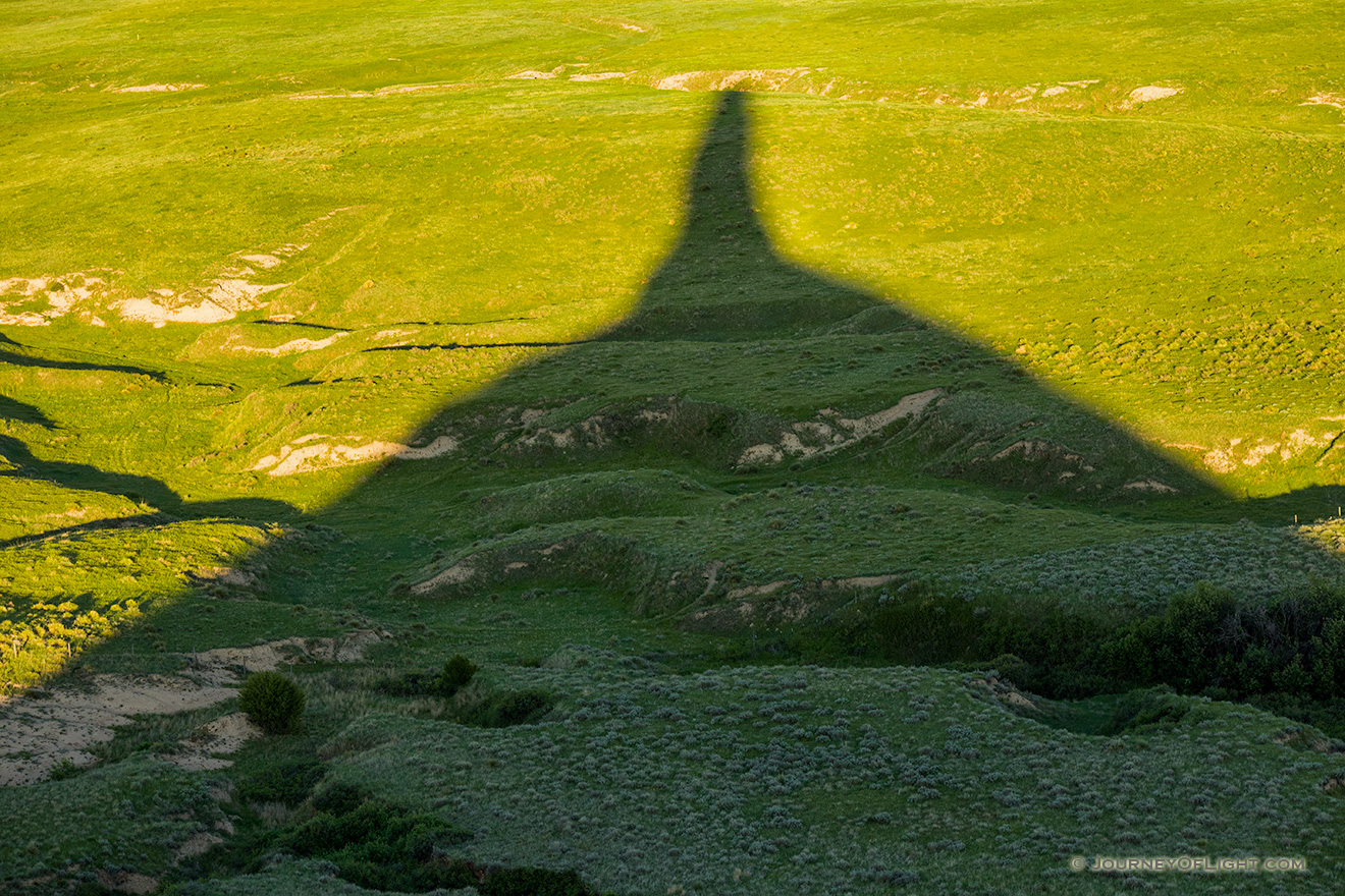 Chimney Rock's shadows stretches out across the plains as the sun dips low in the western sky. - Nebraska Picture