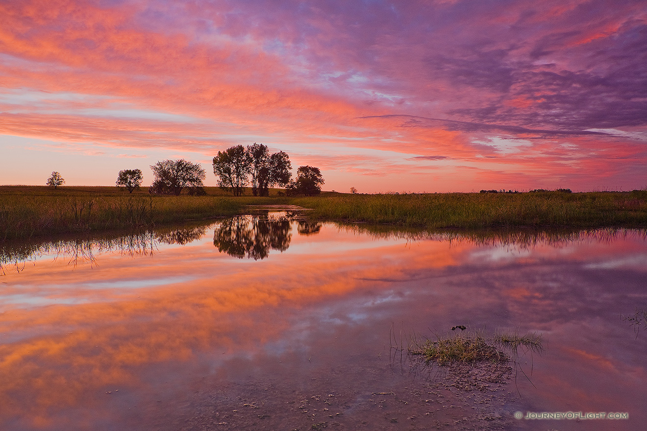 A beautiful sunset reflects off a saltwater marsh in eastern Nebraska near Lincoln. - Nebraska Picture