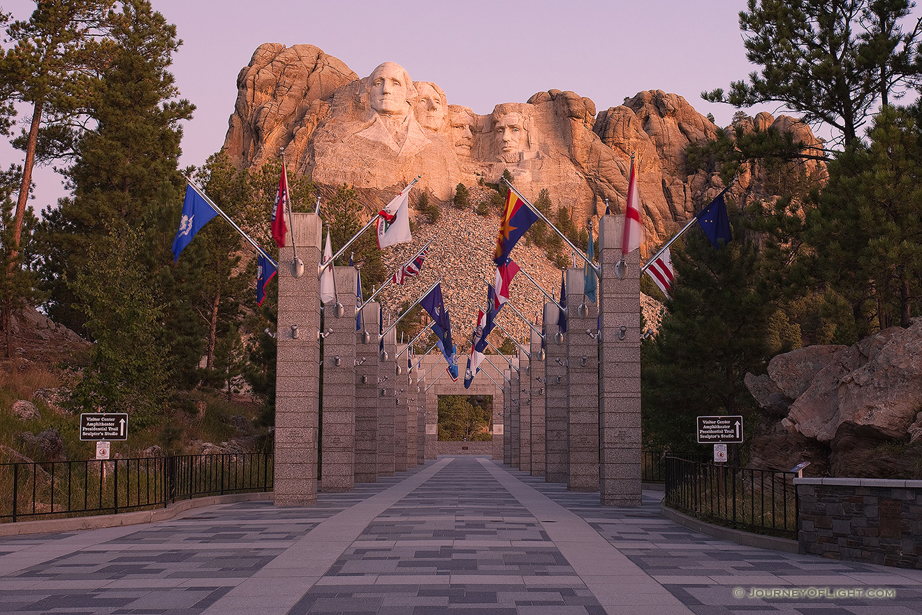 Mt. Rushmore National Monument at sunrise with the Avenue of Flags in the Black Hills of South Dakota. - Mt. Rushmore NM Picture