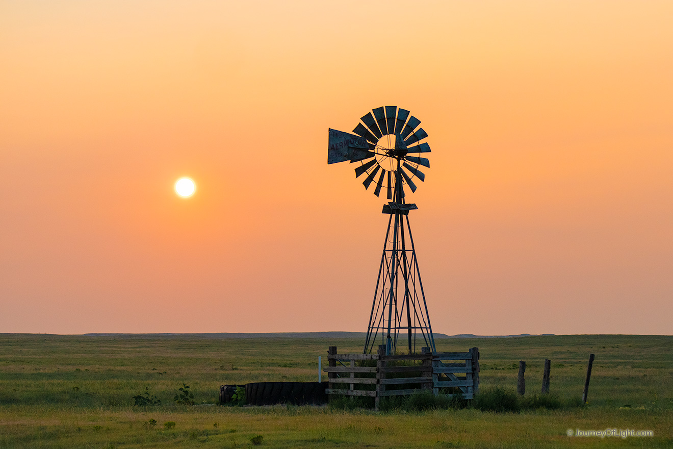 Scenic landscape photograph of a windmill and sun at Oglala National Grasslands. - Nebraska Picture