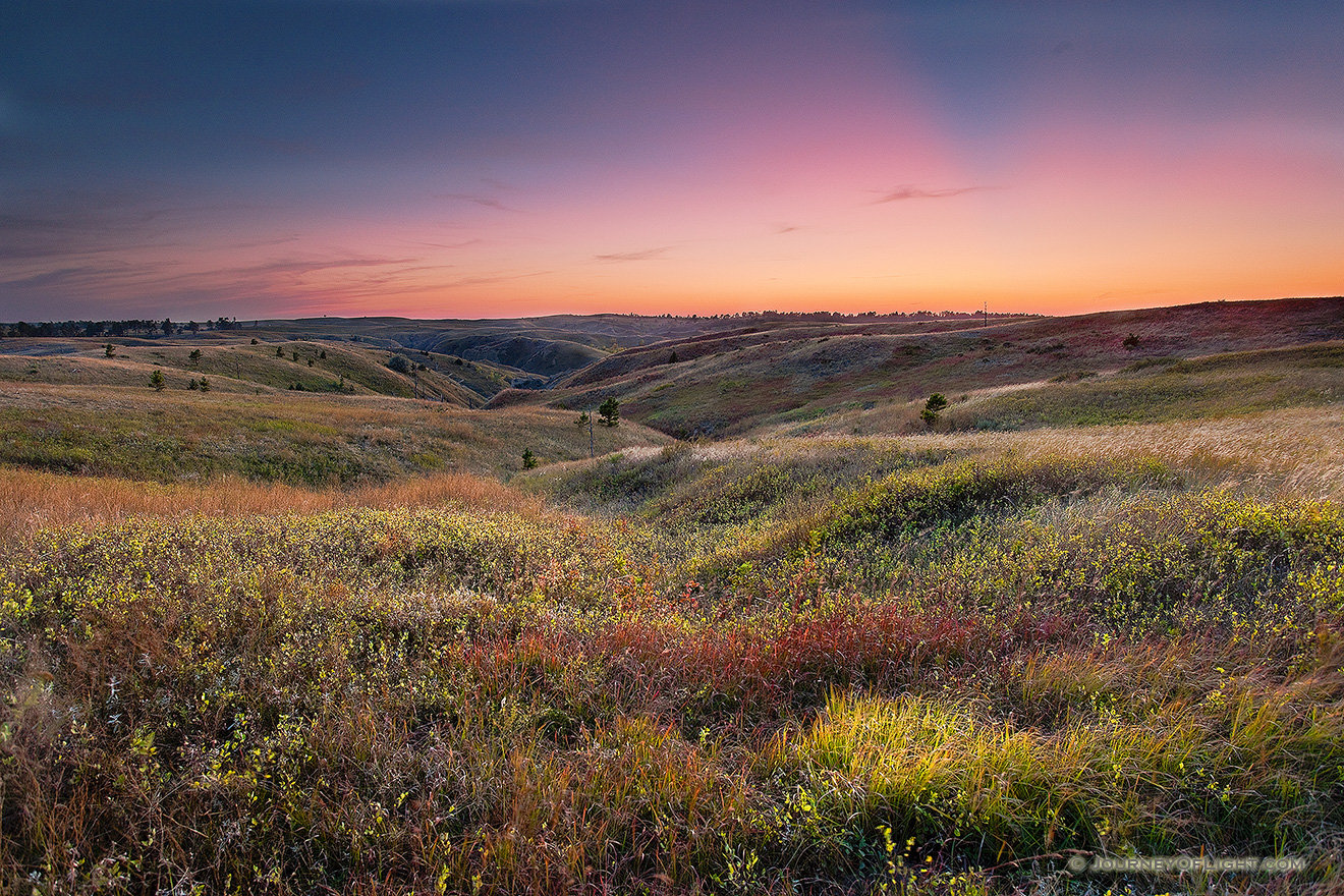 On an early fall evening, the final rays of the sun are briefly visible across Chadron State Park, Nebraska. - Nebraska Picture