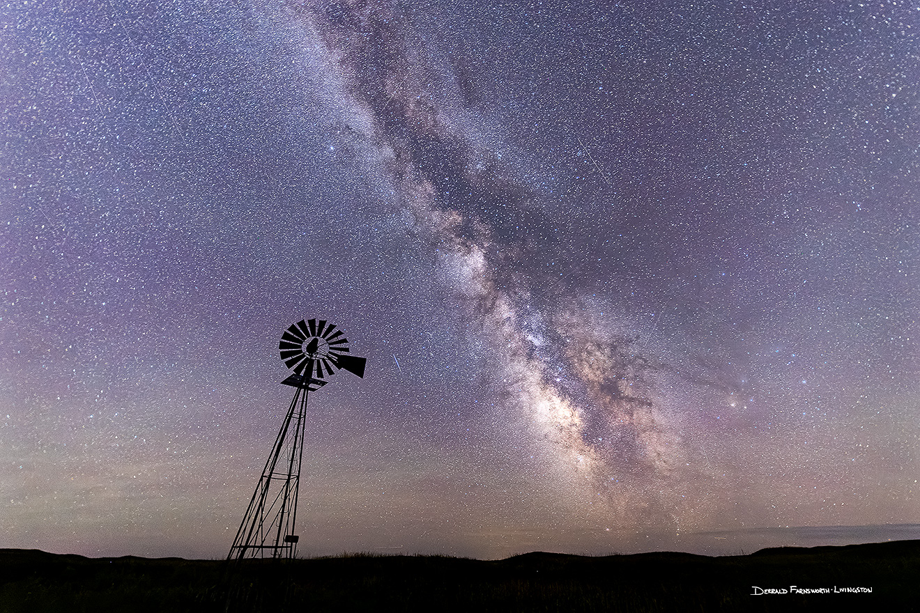A scenic landscape photograph of a windmill and the Milky Way in the sandhills of Nebraska. - Nebraska Picture