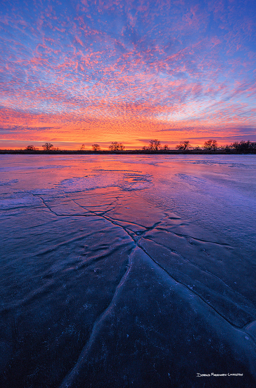 A scenic landscape photograph of a sunset and a frozen lake at DeSoto NWR, Nebraska. - Nebraska Picture