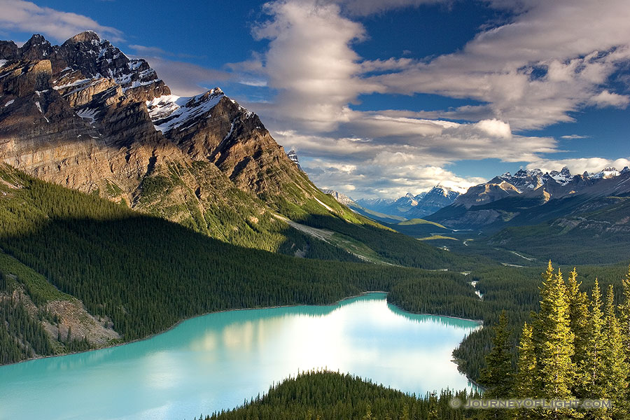 Peyto Lake in Banff National Park is known for its turquoise blue water caused by runoff from the nearby Glacier.  Most photographers will tell you to photograph this scene in the afternoon in order to maximize the reflection of the mountains on the lake.  I, however, wanted to see how it would look in the early morning.  After photographing the sunrise on Bow Lake I traveled the short distance to Peyto Lake to capture this image. - Banff Photography