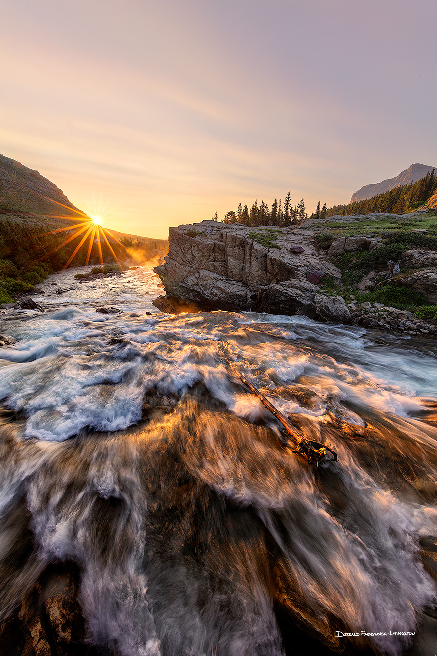 A scenic landscape photograph of sunrise over a waterfall Swiftcurrent Lake, Glacier National Park, Montana. - Glacier Picture