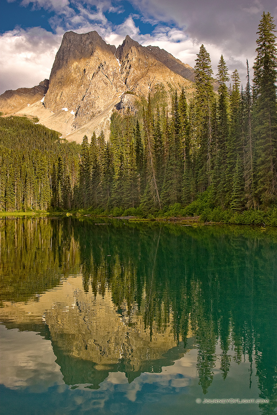After relaxing dinner at the little restaurant that over looks this lake, I captured this photograph.  I enjoyed how the the dappled, warm afternoon sun washed over the mountain.  Emerald Lake in Yoho National Park, British Columbia, Canada. - Canada Picture