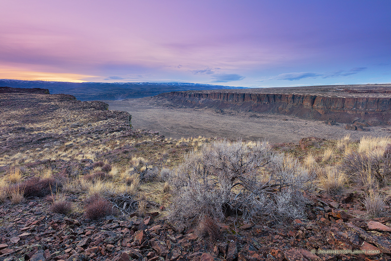 Frechman Coulee in the Columbia River Basin Wildlife Area central Washington is a popular destination for hikers and climbers.  On an unseasonably warm February evening I waited as the sun descended in the distance causing the landscape to be cast in cool purple and blue hues. - Pacific Northwest Picture
